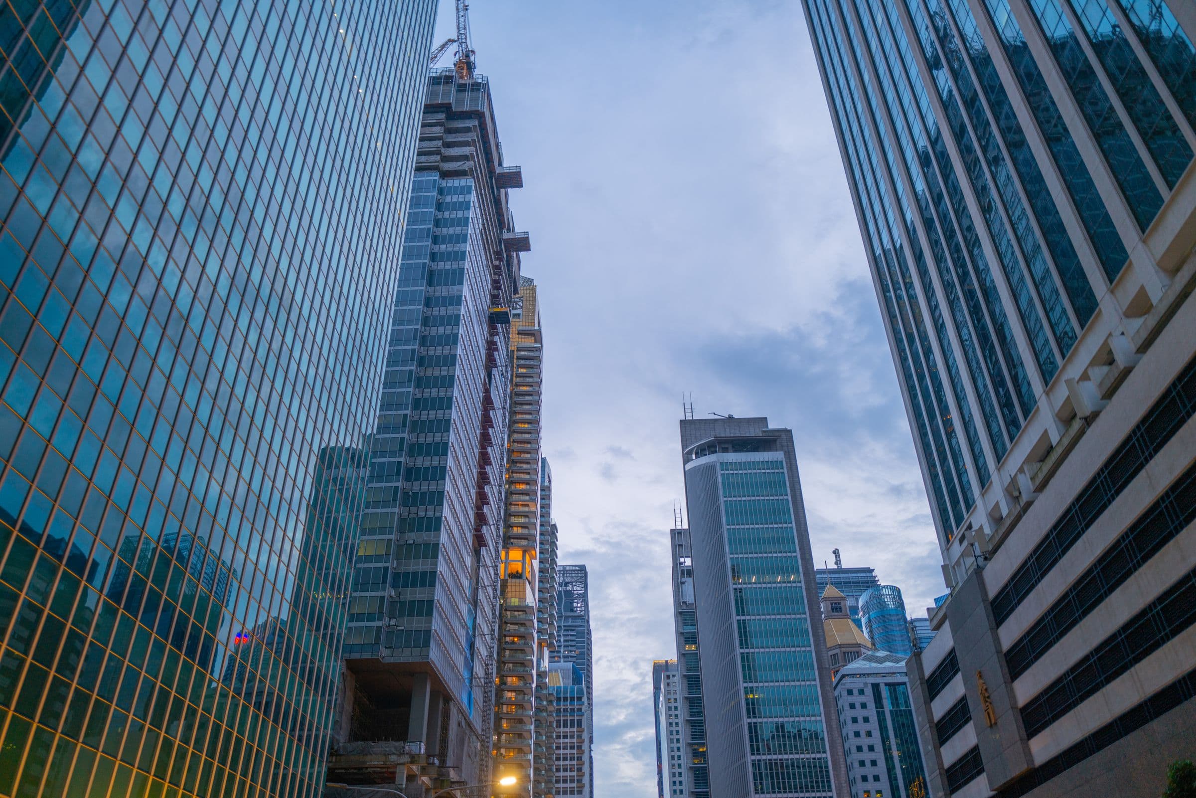 Cluster of financial-district skyscrapers at dusk.