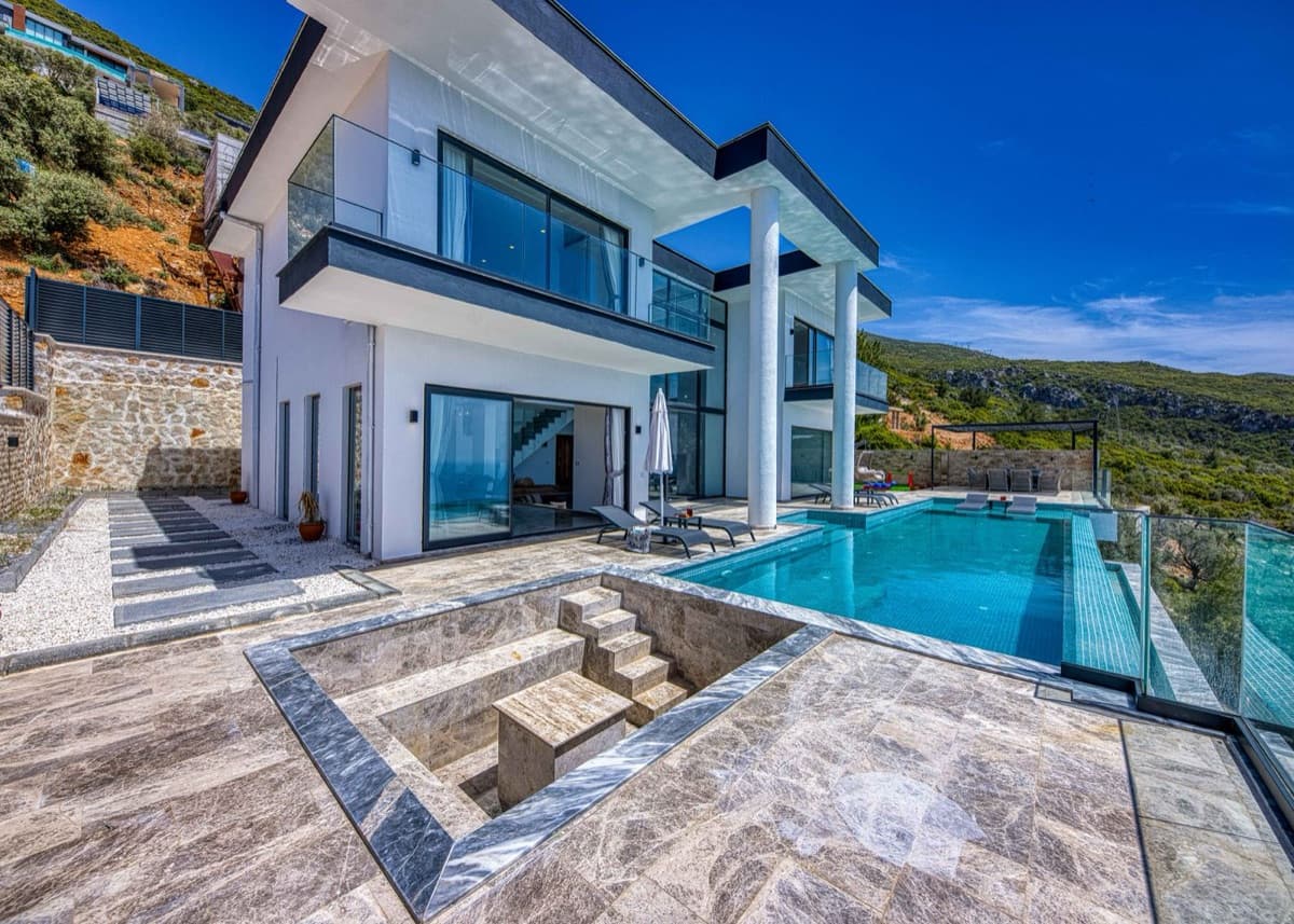 Modern luxury villa with an infinity pool above the coast