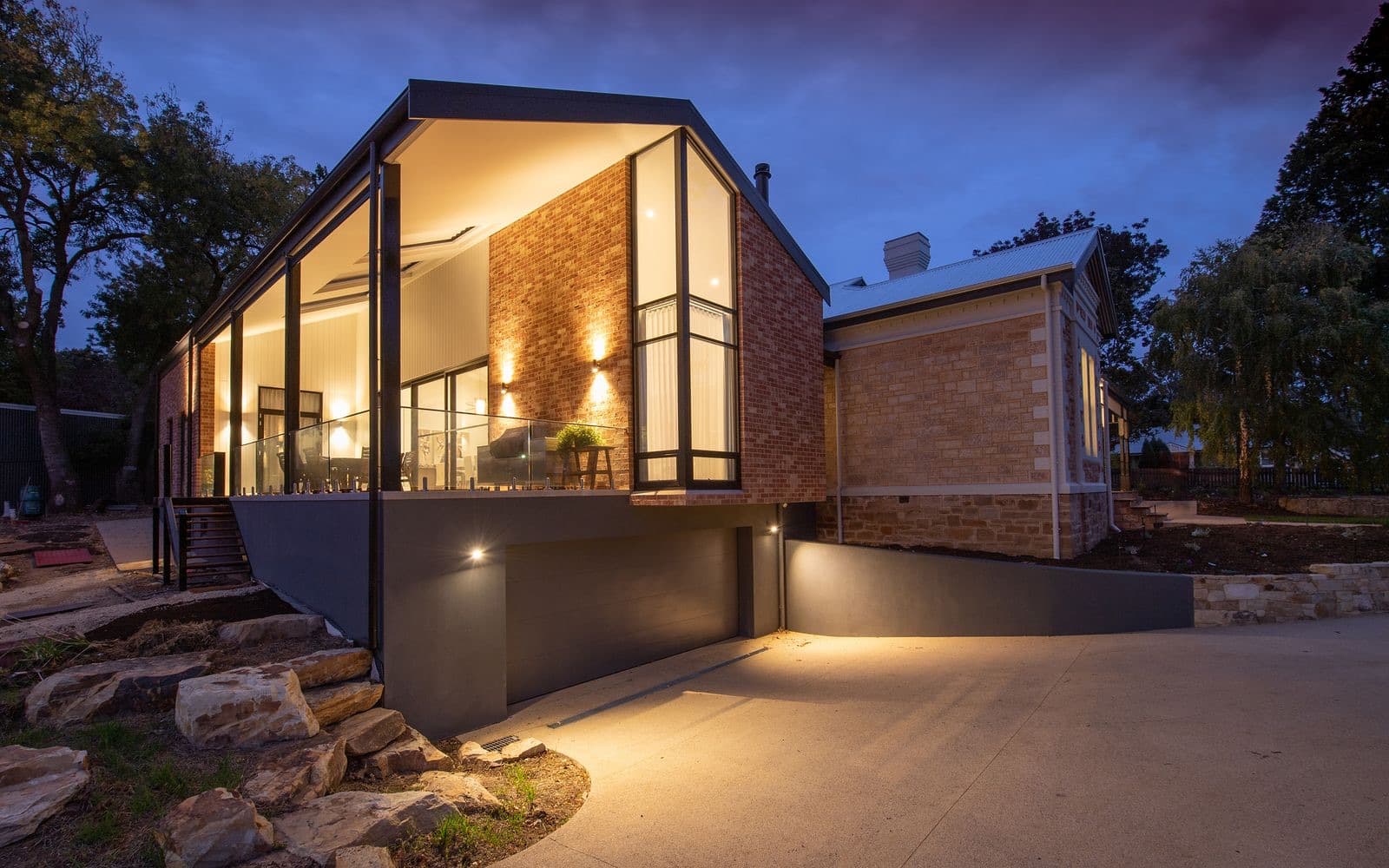 Modern renovated home exterior lit at dusk