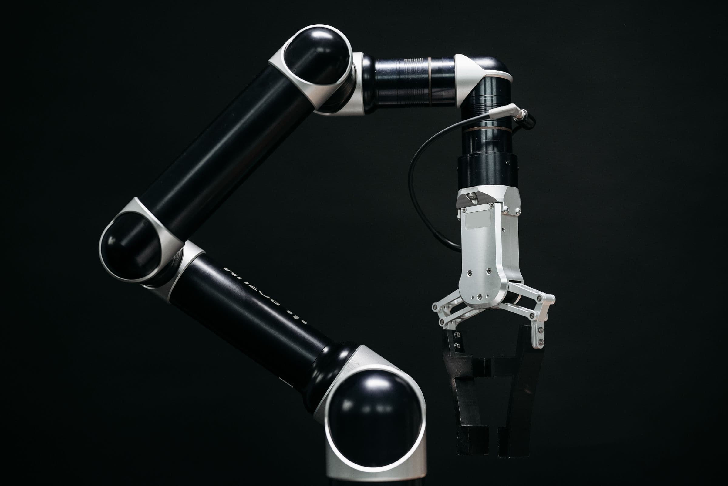 Precision robotic arm against a dark background.